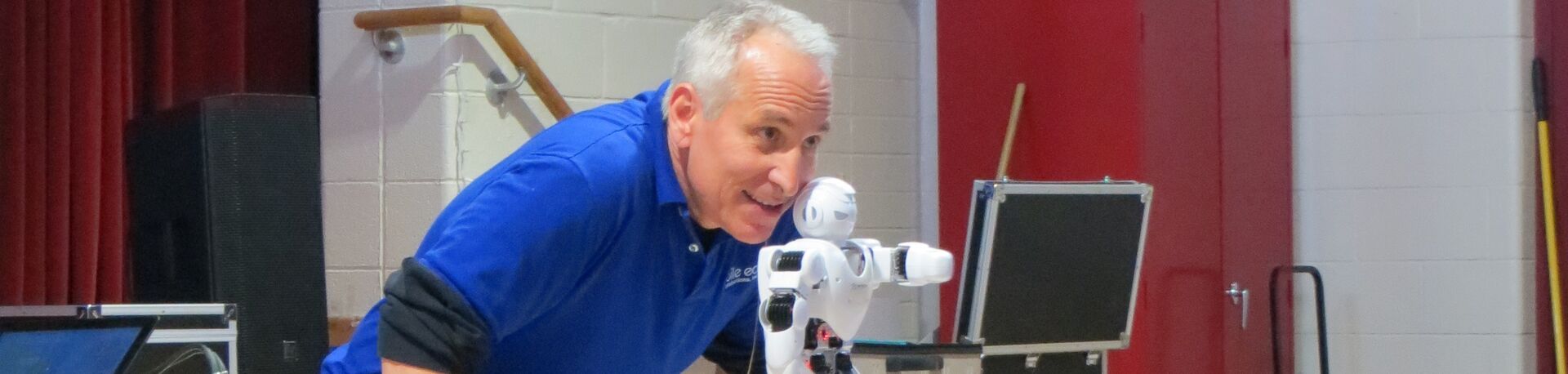 Pete introducing a robot during the BOT! school assembly